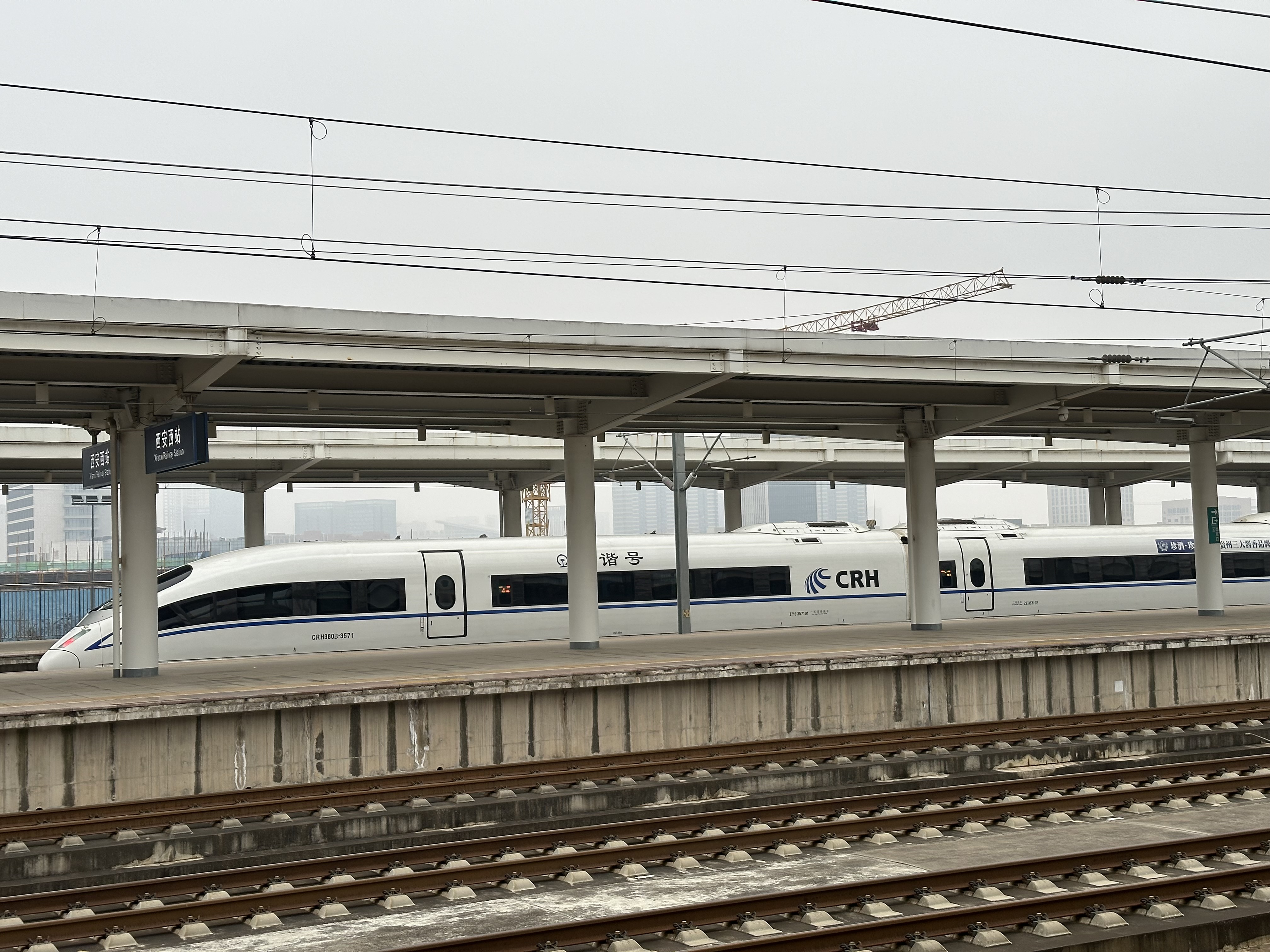 A white-and-blue CRH380B Hexie train at Xi'an West Railway Station — another long-nosed workhorse of the high-speed network