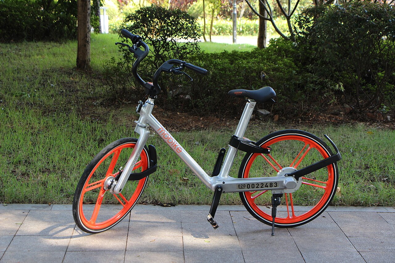 A Mobike shared bike parked on a city street - scan the QR code with Alipay or WeChat to unlock